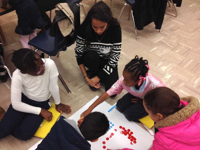 Swaksha Rachuri, senior, biochemistry major, teaching the lesson, "Egg Carton Designs." 